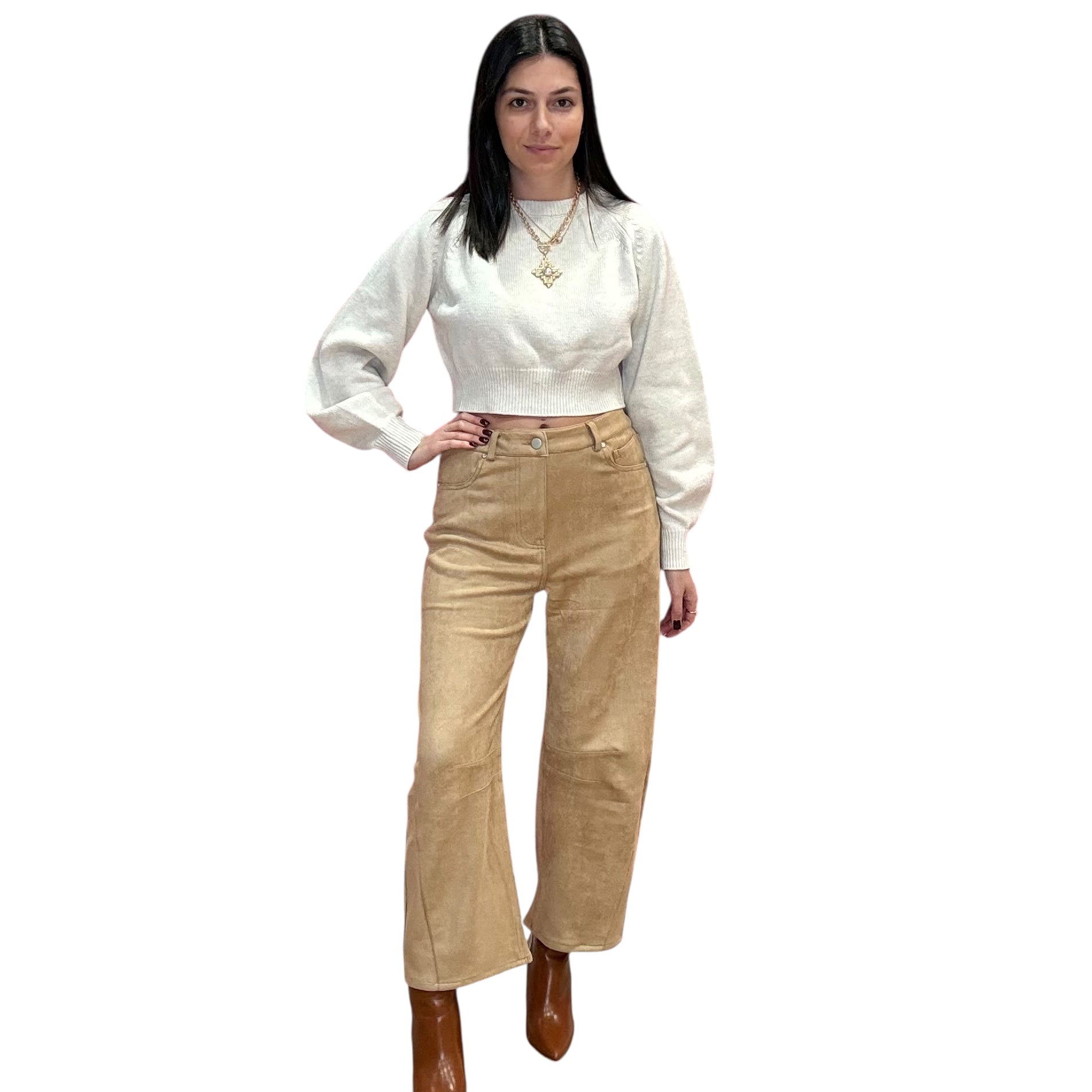 Woman wearing a off white long-sleeve sweater and camel suede barrel pants on a white background