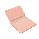Pink leather passport cover on a white background