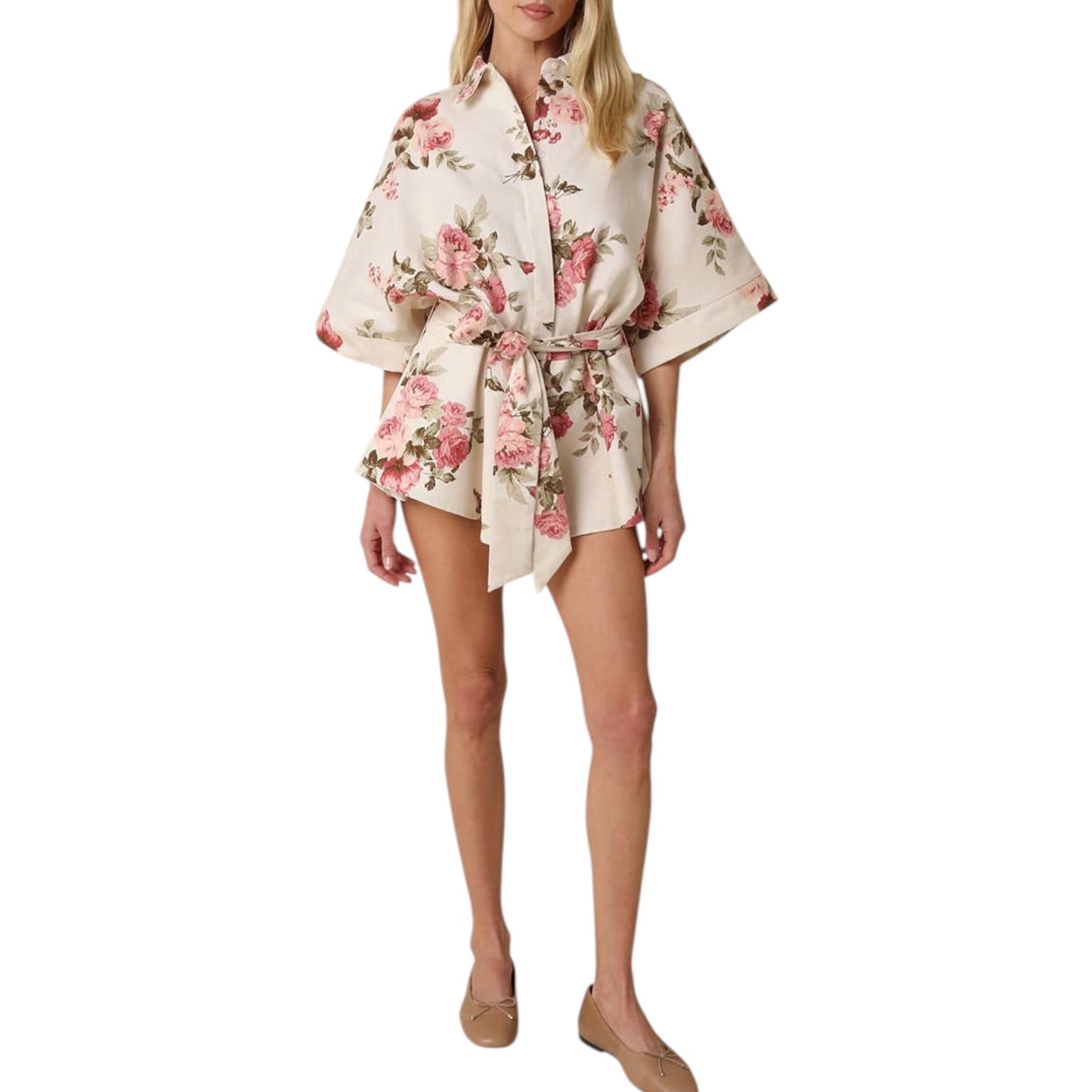 Woman wearing a floral kimono-style outfit on a white background