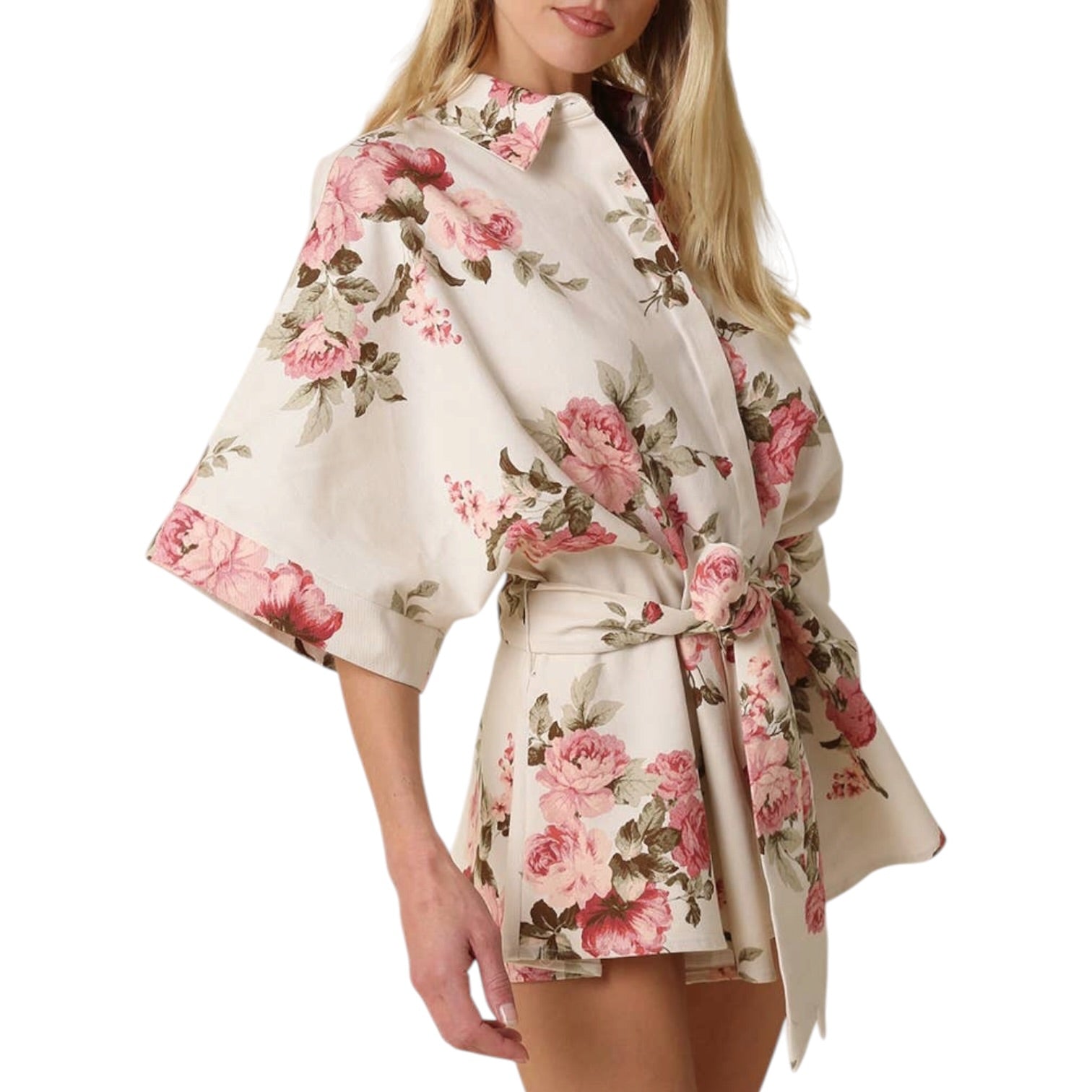 Woman wearing a floral kimono-style garment on a white background