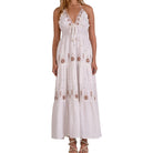 White dress with floral embroidery on a white background