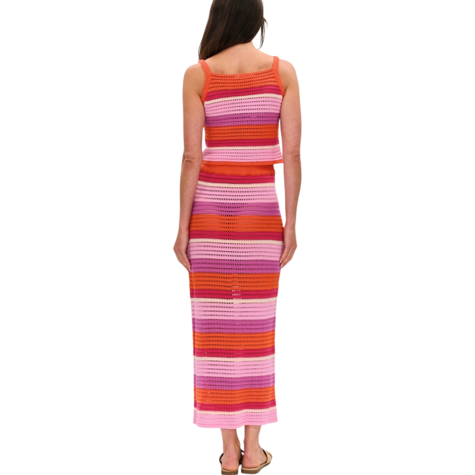 Woman wearing a colorful striped set on a white background