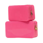 Two pink toiletry bags with gold zippers on a white background