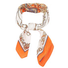 Colorful patterned scarf with orange accents on a white background