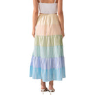 Woman wearing a colorful striped skirt on a white background