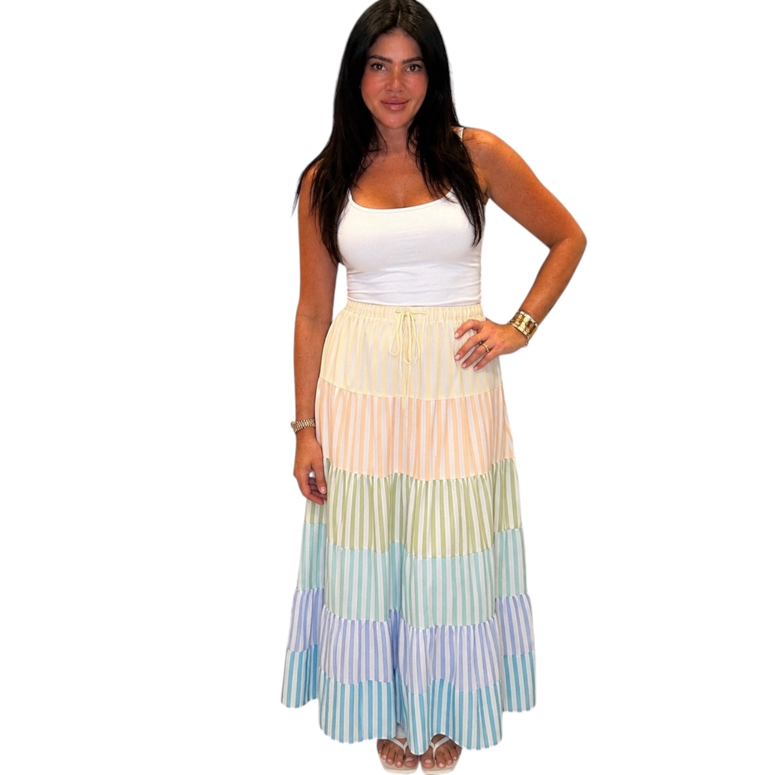 Woman wearing a colorful tiered dress on a white background