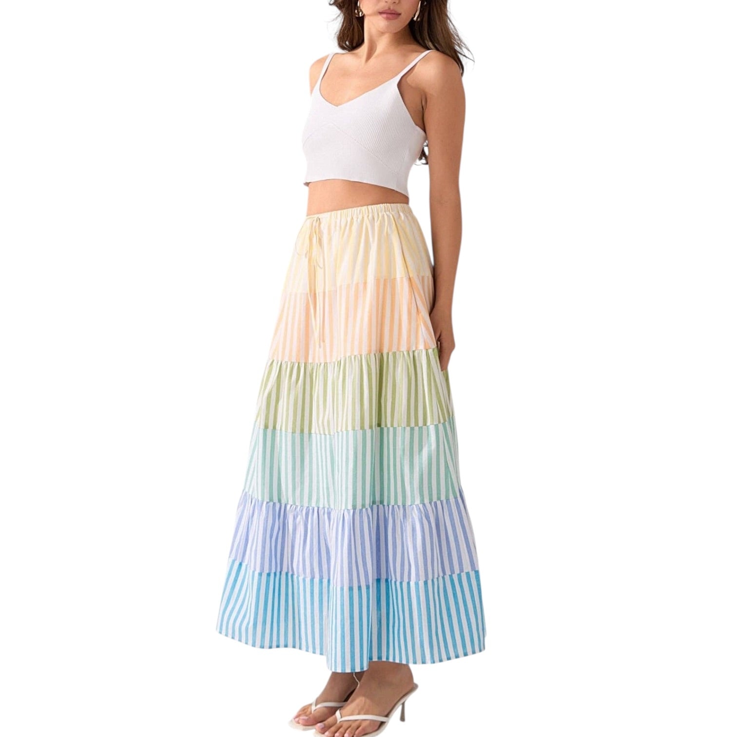 Woman wearing a colorful striped skirt on a white background