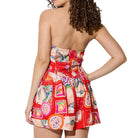 Woman wearing a colorful strapless romper with a pattern on a white background