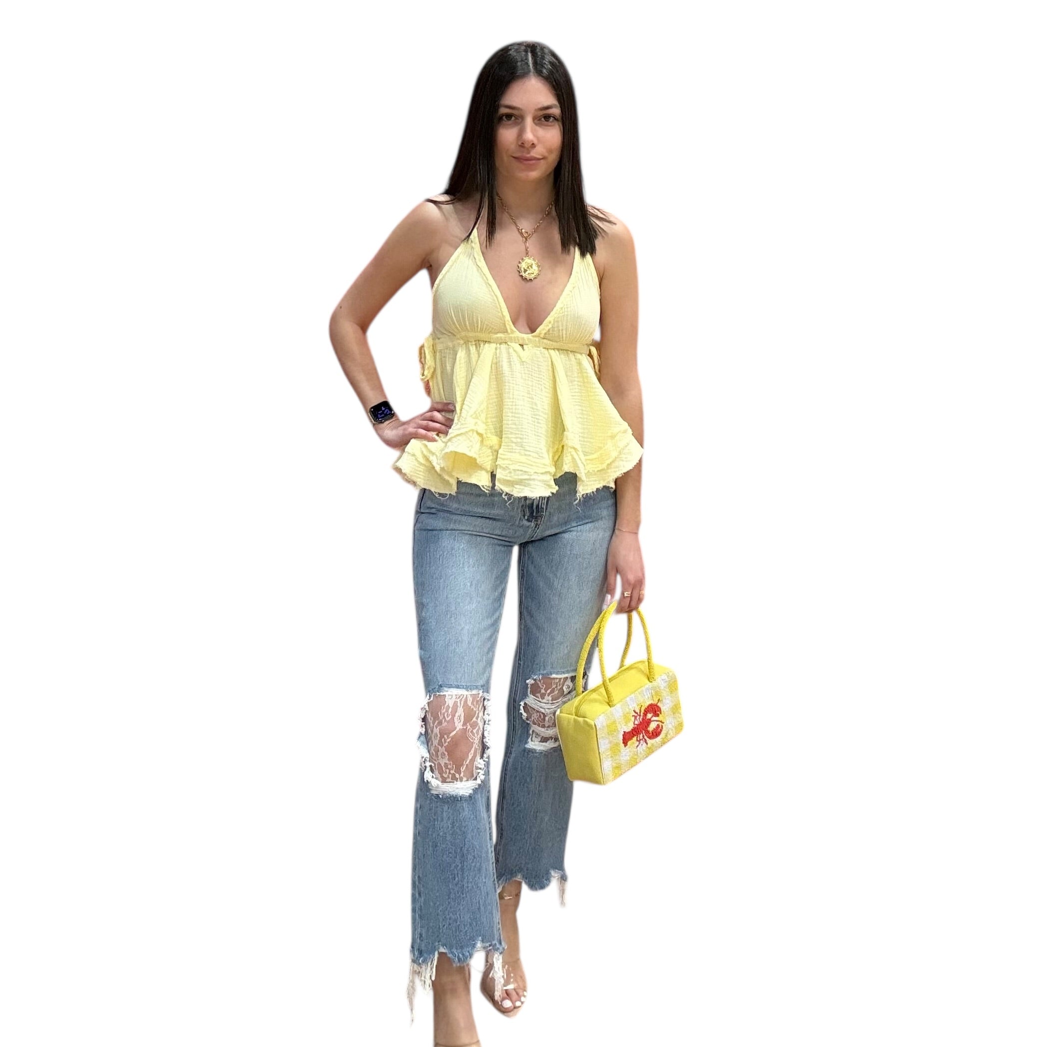 Woman wearing a yellow top and blue jeans, holding a yellow handbag on a white background