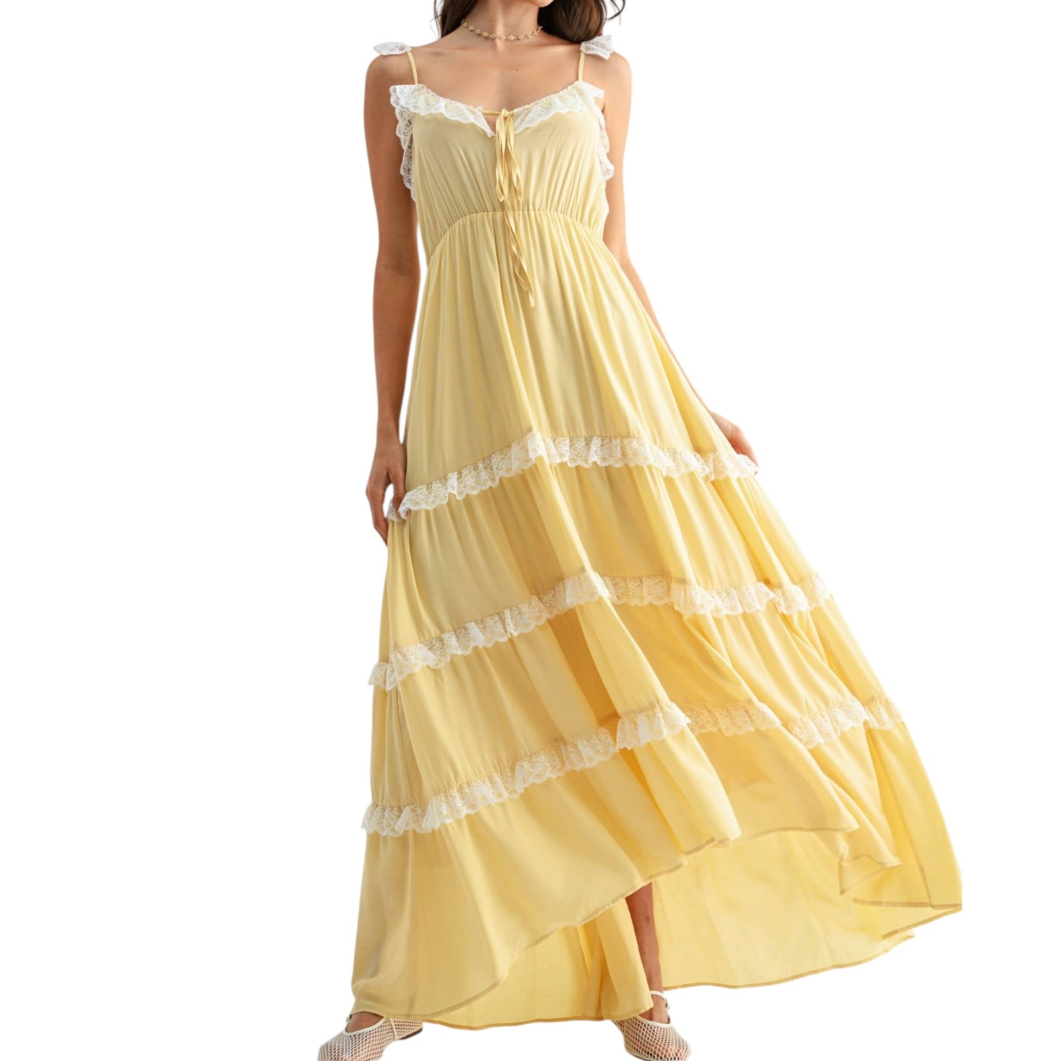 Yellow dress with lace details on a white background