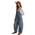 Woman wearing denim overalls and a straw hat on a white background