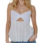 Woman wearing a white top and blue jeans on a white background
