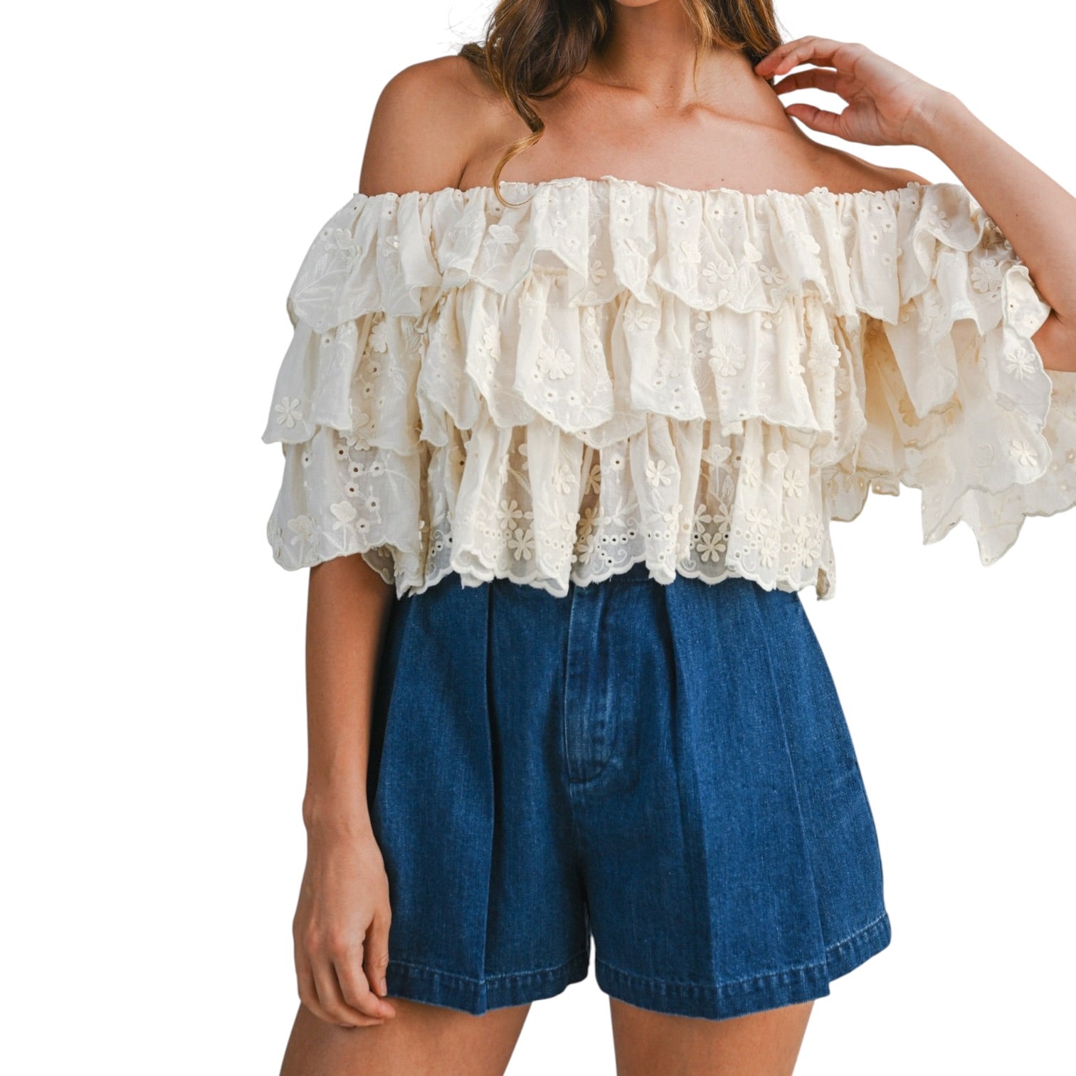 woman wearing tiered off shoulder lace top with pleated denim shorts
