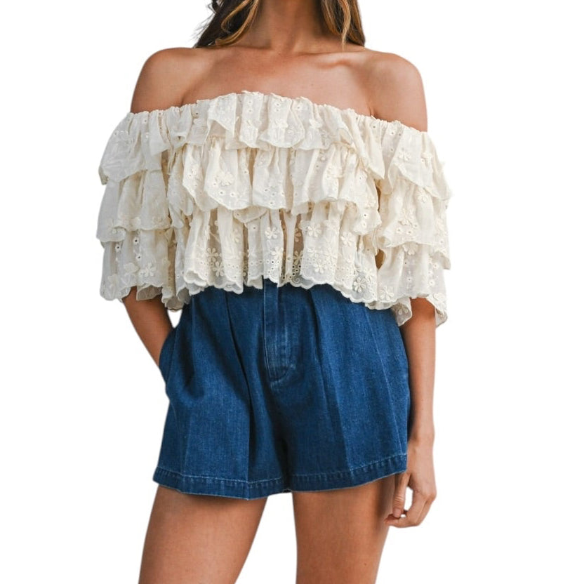 woman wearing tiered off shoulder lace top with pleated denim shorts