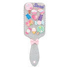 A rhinestone-covered hair mirror with a pink bow on the handle and an array of colorful 3D candy and dessert charms on the reflective surface, including lollipops, gummy bears, a pink heart, and a pink script word that appears to read 'Sweet'.