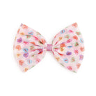 Large fabric bow with colorful heart patterns on a white background