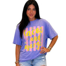 Person wearing a purple t-shirt with 'tacos and marg' text on a white background