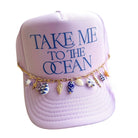 Lavender cap with 'Take Me to the Ocean' text and beach-themed charms on a white background