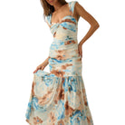 Woman wearing a floral one-shoulder dress on a white background