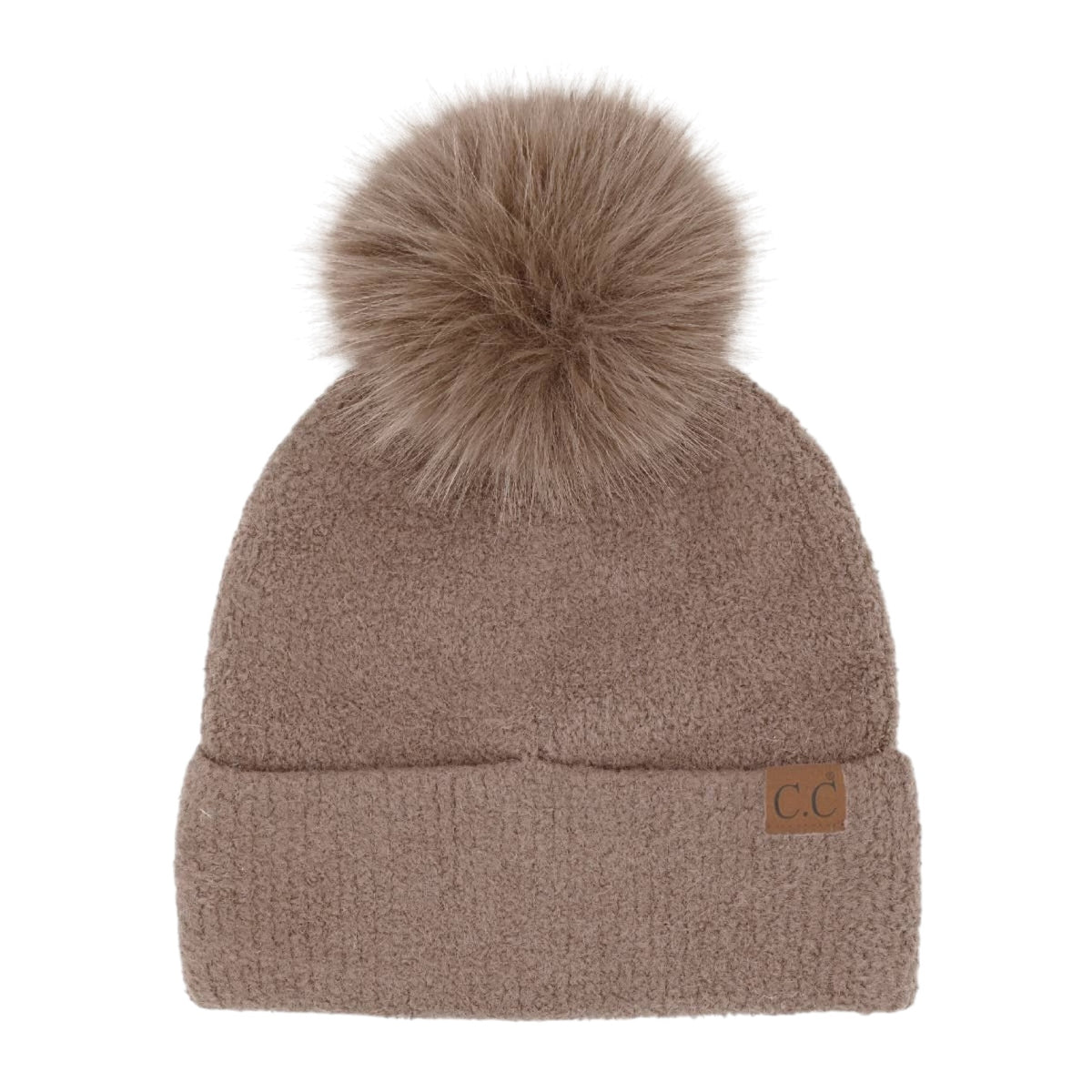 A taupe brown knit beanie hat featuring a large matching faux fur pom-pom on top and a small brown leather 'CC' logo patch on the folded cuff, shown against a plain white background.