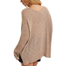 Beige knitted sweater worn by a person on a white background