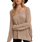 Woman wearing a beige knitted sweater on a white background