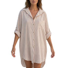 Woman wearing a striped shirt dress on a white background