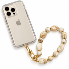 A clear iPhone case with a gold-tone clasp attached to a beaded phone strap made of cream and tan marbled beads separated by small gold spacer beads, shown on a white background.