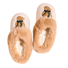 A pair of plush slip-on slippers with a cream-colored top, tan faux-fur trim, and an embroidered teddy bear with a dark green bow on each shoe, shown against a plain white background.