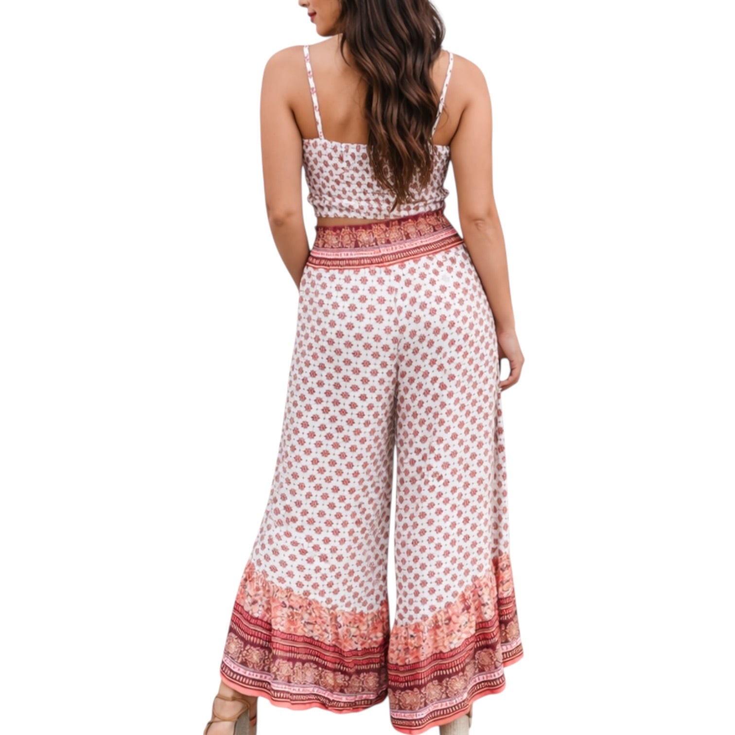 Woman wearing a patterned jumpsuit on a white background