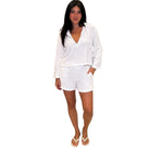 Woman wearing a white outfit on a white background