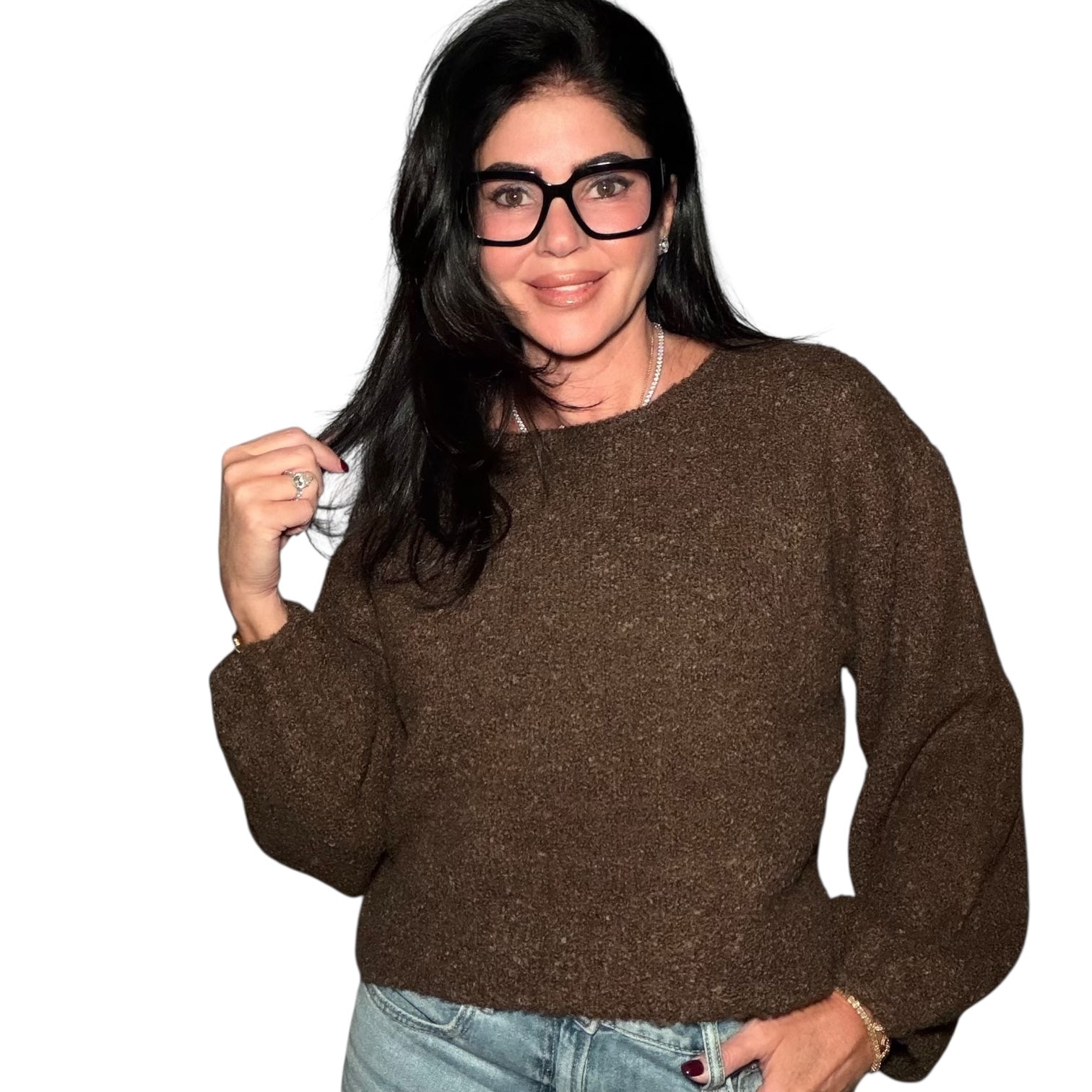 Woman wearing a brown sweater and glasses on a white background