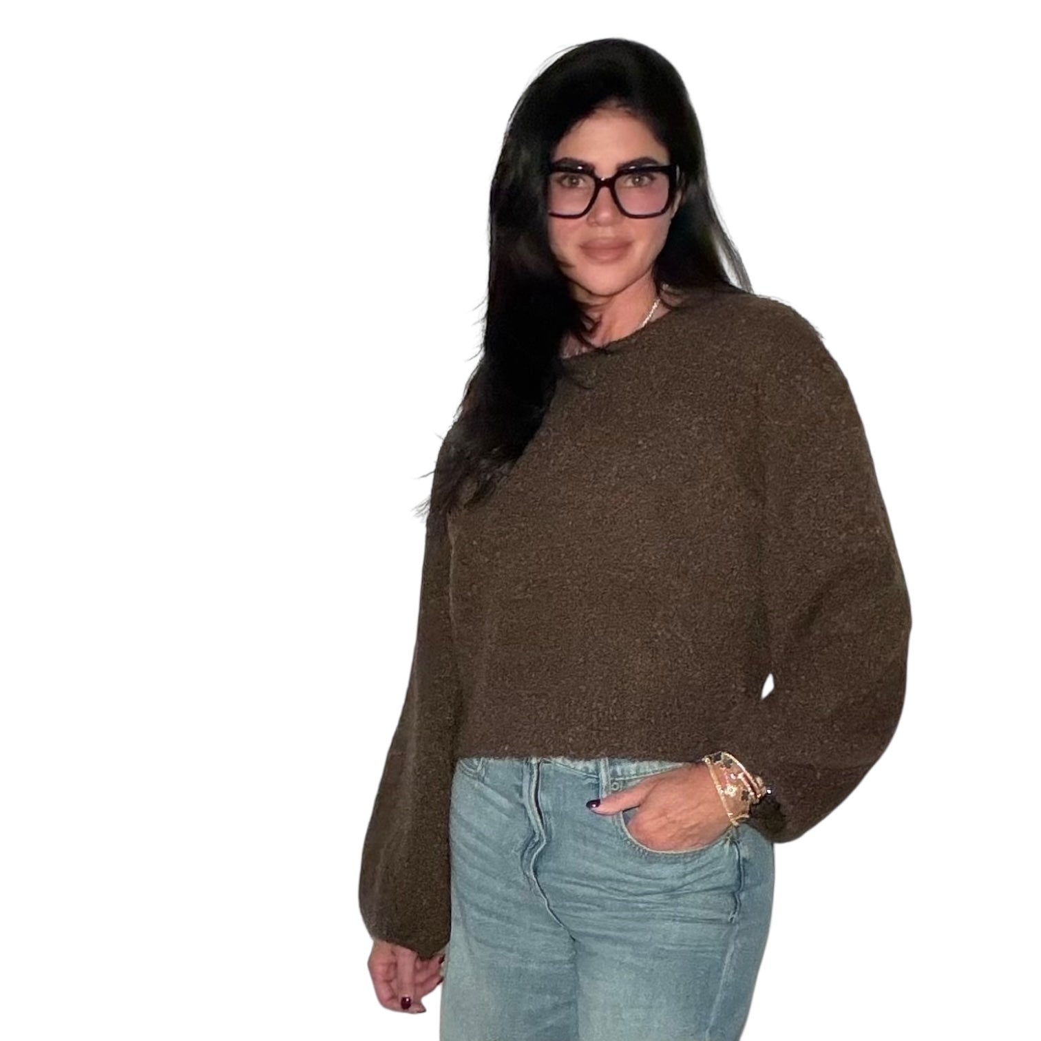 Woman wearing a brown sweater and blue jeans on a white background