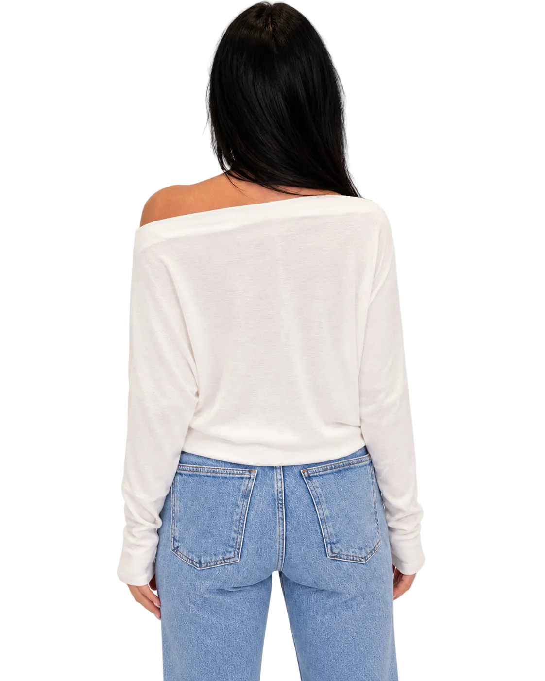 A woman viewed from the back wearing a cream off-the-shoulder long-sleeve top and light blue jeans against a plain white background.