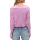 Person wearing a violet long-sleeve top and blue jeans on a white background