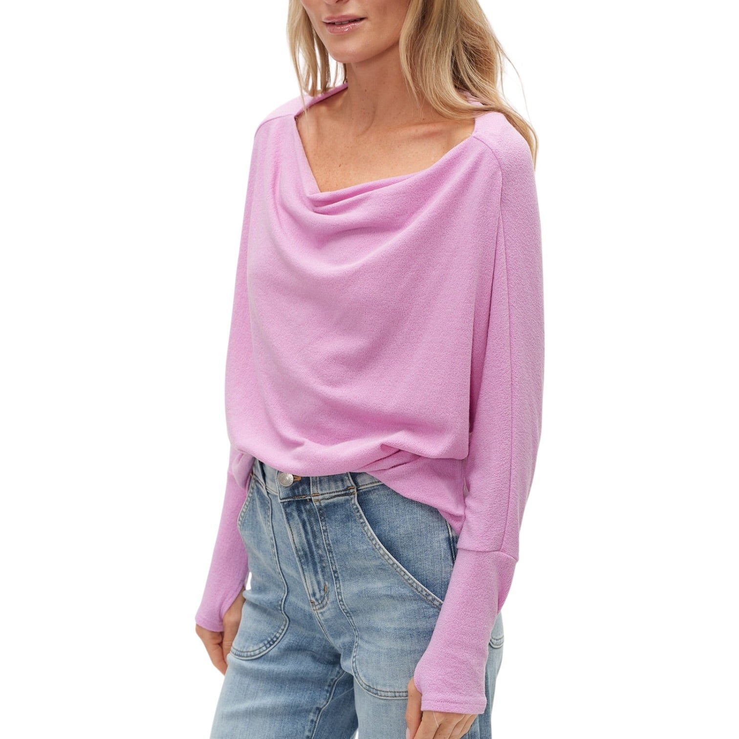 Woman wearing a violet sweater and blue jeans on a white background