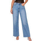 A model wearing a pair of light blue wide-leg denim jeans, paired with a dark brown top and clear high-heeled sandals, shown against a plain white background.