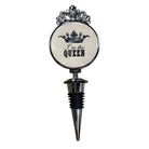 A novelty wine bottle stopper featuring a round white face with a black crown graphic and the text 'I'm the QUEEN' in black script and block lettering. The top of the round section is decorated with a silver-toned crown-like embellishment, and the stopper body below is silver metal with a black rubber grommet.