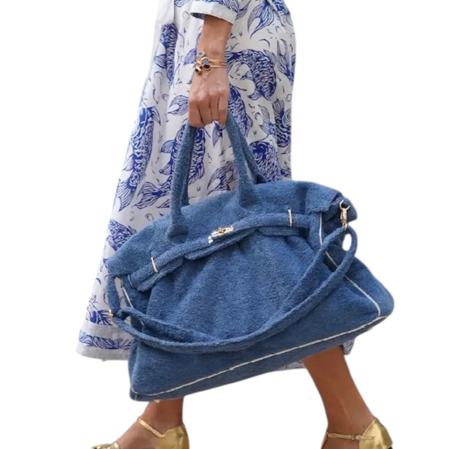 Person holding a blue denim bag with a white background