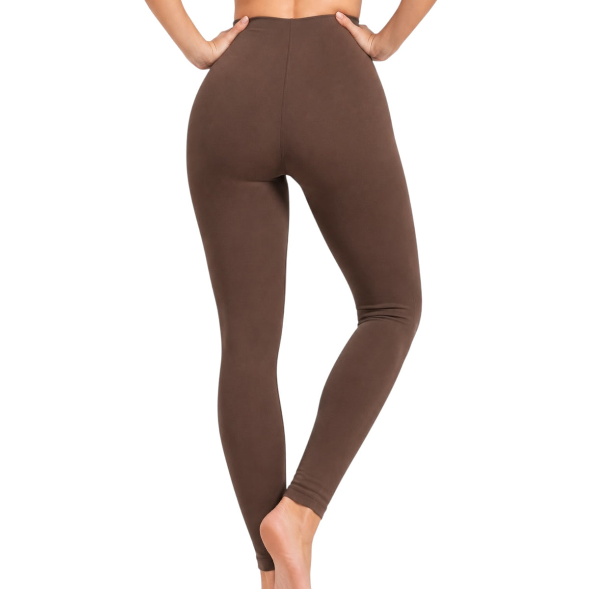 A person modeling high-waisted, full-length leggings in a solid dark brown color, shown from the back against a plain white background.