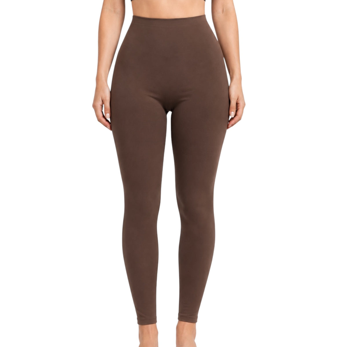 A model wearing high-waisted, form-fitting brown leggings against a plain white background.