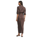 Woman wearing a brown jumpsuit on a white background