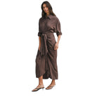 Woman wearing a brown satin dress on a white background