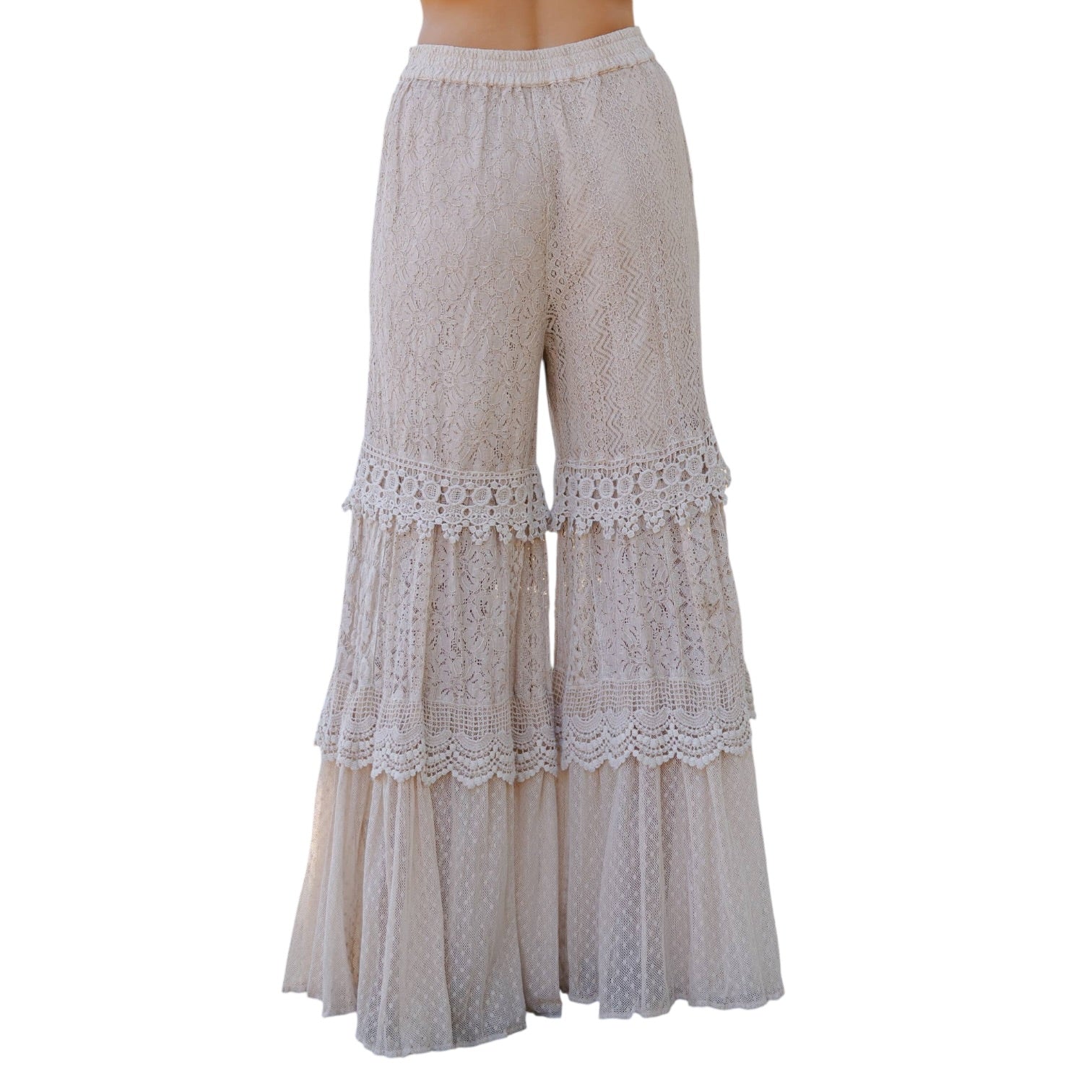 Beige lace-trimmed pants on a white background