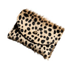 A leopard print cowhide cardholder with a black snap button closure, isolated on a white background.