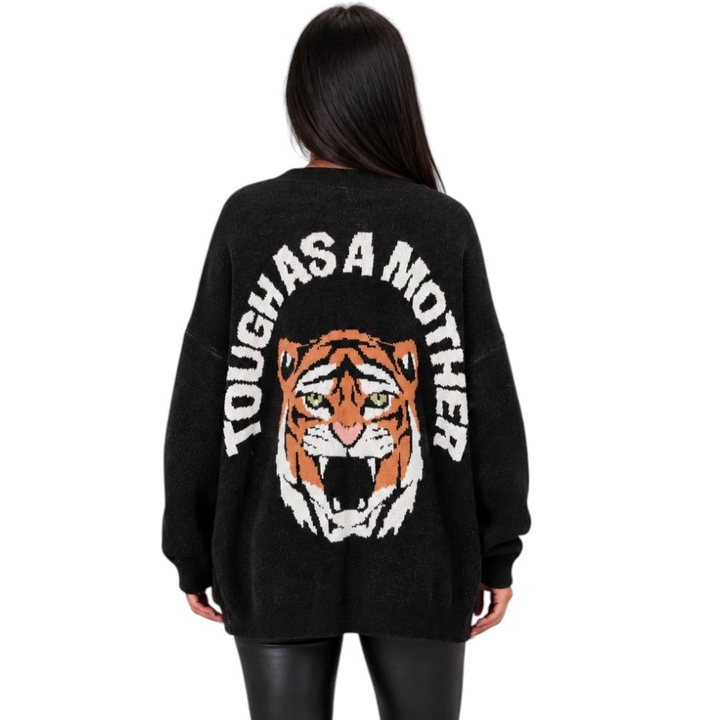 A woman viewed from the back wearing a black knit sweater with a large tiger face graphic and the words 'TOUGH AS A MOTHER' in white around the upper back.