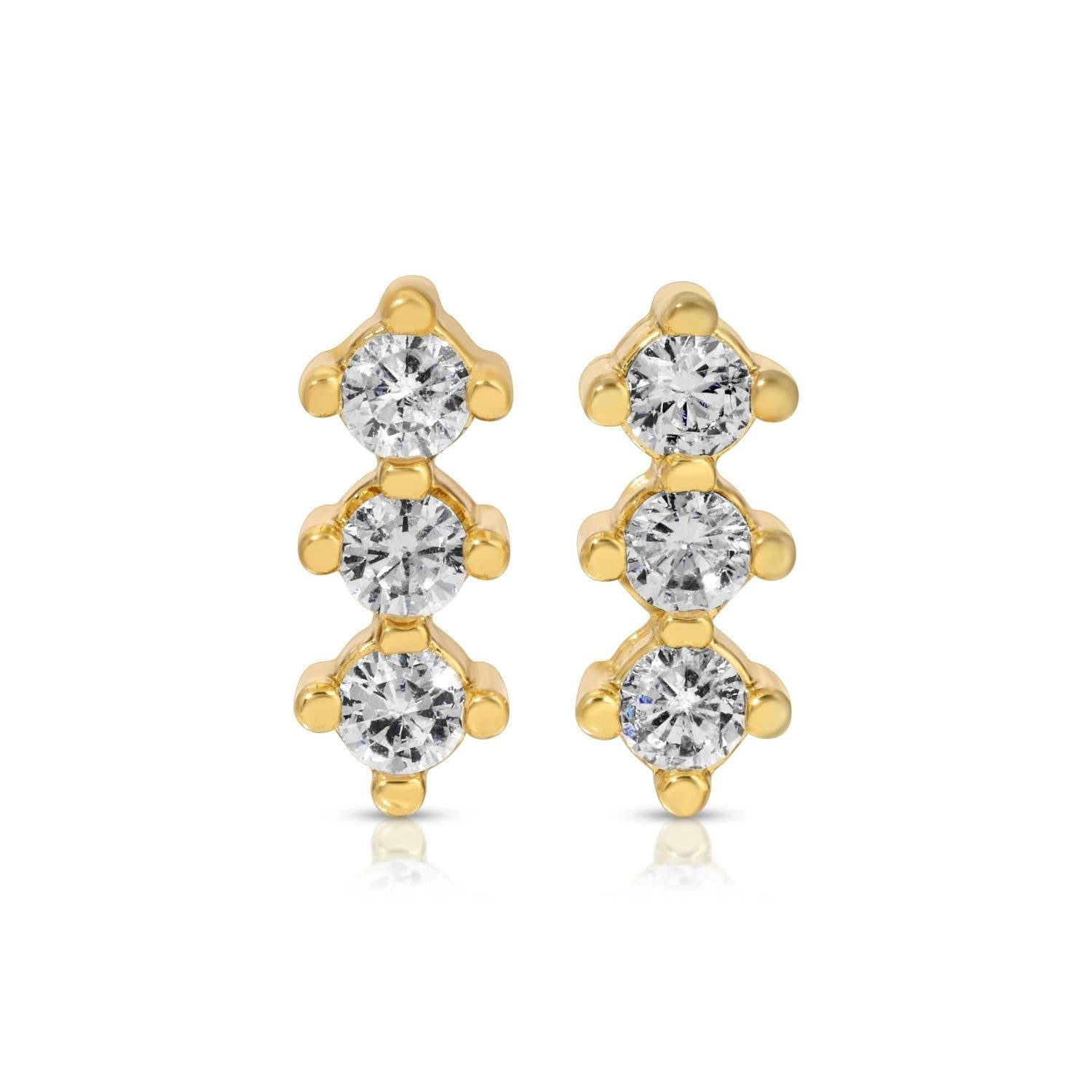 Gold earrings with clear gemstones on a white background