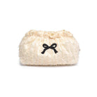 White fluffy pouch with a black bow on a white background