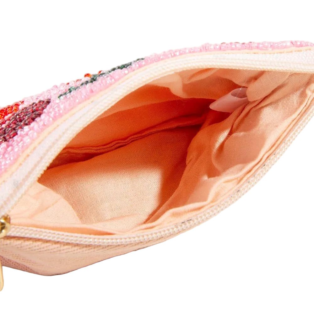 Close-up of a pink beaded pouch with a gold zipper on a white background
