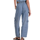 Light blue cargo pants worn by a person on a white background